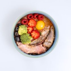 Bowl of raw pet food and toppers